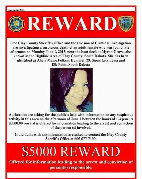 A red and white reward poster dated December 2015 with Alicia Hummel’s photo, offering $5,000 and listing the Clay County Sheriff’s Office number