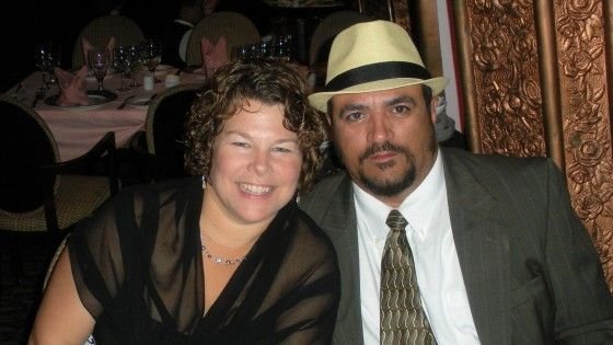 Betsy Faria and Russ Faria seated together at a dinner table