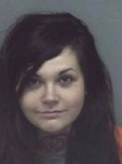 Amanda Taylor in a booking photo, with long dark hair