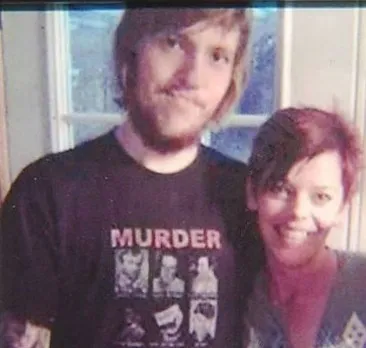 Rex Taylor and Amanda Taylor standing together and smiling, in a framed photo