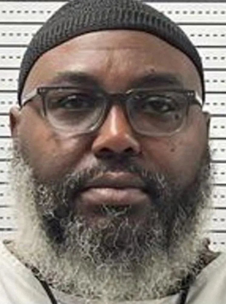 Tadaryl Shipp, with a gray beard, glasses and a knit cap, in a prison photo