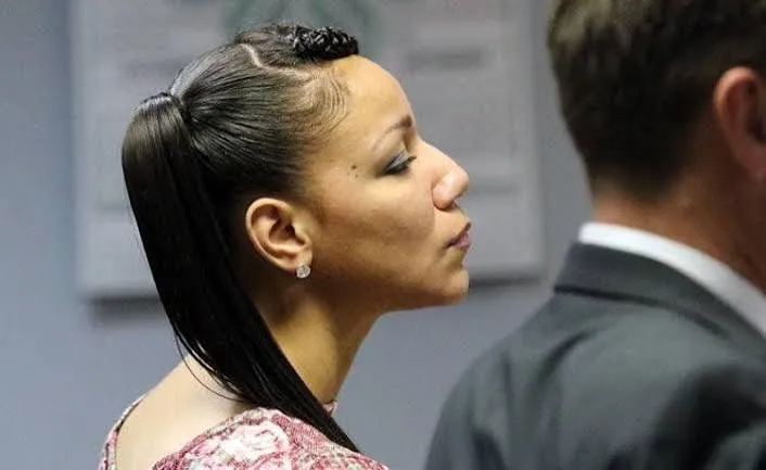 Erica Jenkins in profile in a courtroom, her hair pulled back in a long ponytail