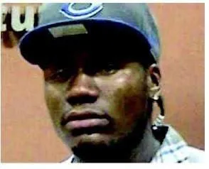 Curtis Bradford in a blue baseball cap and an earring