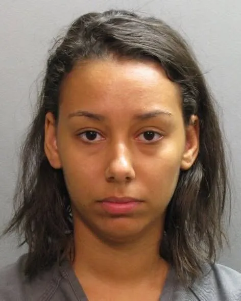 Booking photo of Lark Hodge in a gray jail uniform